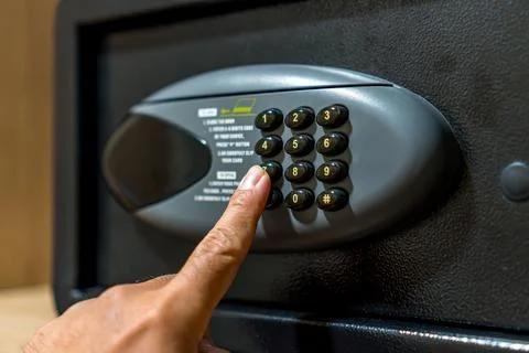 Hand Entering Security Code on Digital Safe Box Stock Photos