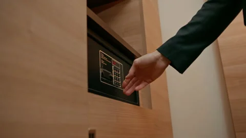 A hand enters a code to open and lock a safe or safe in a hotel room Theft or Stock Footage 237892621