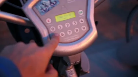Hand enters PIN code on display of rental bike and taking it. Stock Footage 62373263
