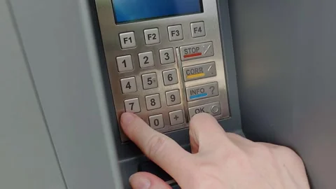 Hand enters a PIN code on a payment terminal keypad. Stock-Footage 345589492