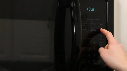 Hand enters time on microwave Stock Footage 61350641