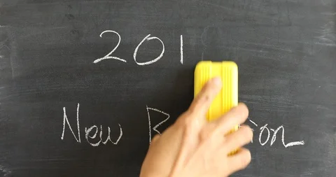 Hand erasing 8 from 2018 and writing 9 on 2019 on blackboard Stock Footage 100753362