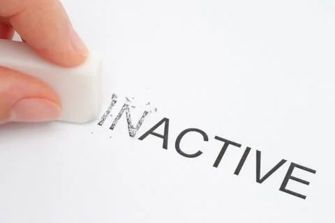 Hand erasing part of the inactive word. Stock Photos