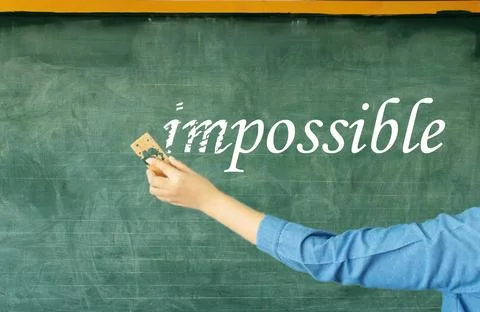 Hand erasing prefix of impossible on chalkboard Stock Photos