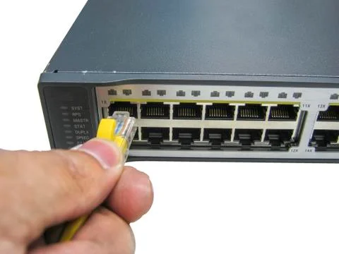 Hand with ethernet cables connected to servers Stock Photos