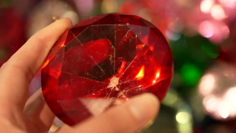 Hand examines large imitation gem close up Stock Footage 153555943