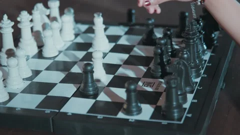Hand Executing a Tactical Chess Move with Black Pawn Video stock 280554036