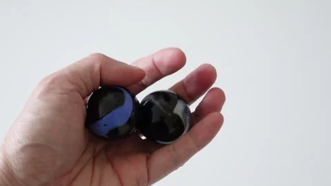 Hand exercising with rotating Baoding balls for relaxation and dexterity Stock Footage 256079463