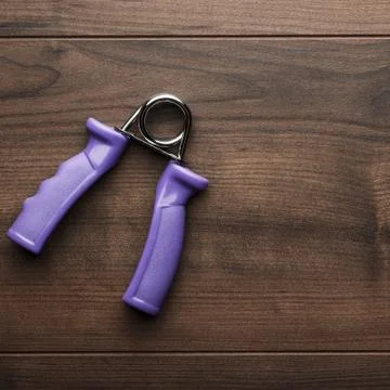 Hand expander on the table Stock Photos