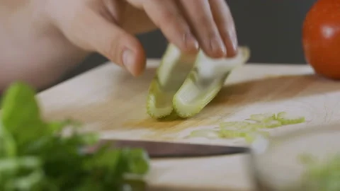 Hand of an expert chef cuts celery Stock Footage 92014745