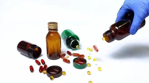 Hand falling pills from pharmaceutical bottle Stock Footage 167219277