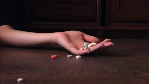 Hand falls dropping pills, pill overdose. Commit suicide, Drug overdose concept. Stock-Footage 200540791