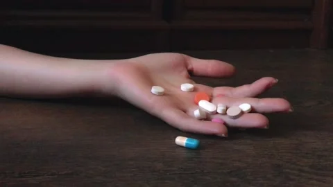 Hand falls dropping pills, pill overdose. Commit suicide, Drug overdose concept. Stock-Footage 200540975
