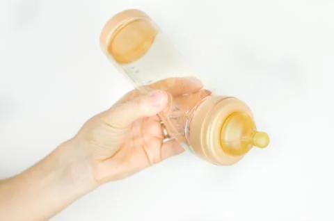 Hand feeding bottle Stock Photos