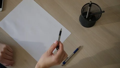 Hand of female drawing pattern at paper. Woman's hand draws with pen Stock Footage 98094229
