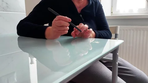 Hand Files Fingernails While Sitting at Glass Table in Indoor Grooming Scene Video stock 328969176
