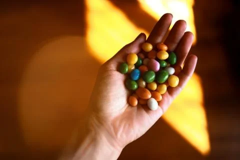 Hand filled with assorted bean candies Stock Photos