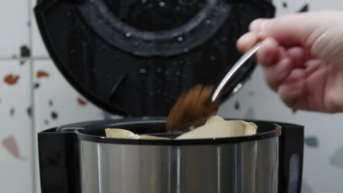 A hand filling a coffee machine with coffee powder. Stock Footage 266417939