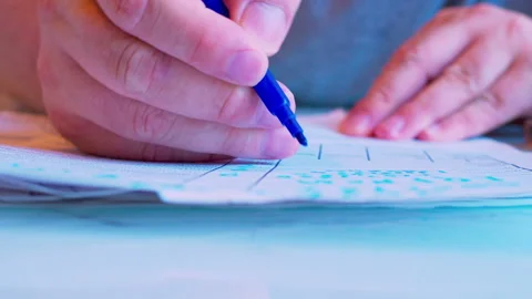Hand filling out a paper document with a marker on a table Stock Footage 336692019