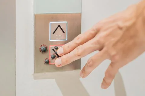 Hand finger press button in elevator with virus. Covid-19 or Coronavirus in the Stockfoto's