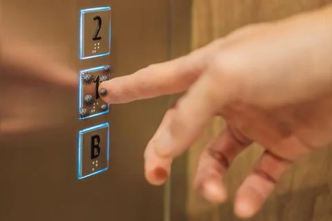 Hand finger press button in elevator with virus. Covid-19 or Coronavirus in the Fotos de archivo