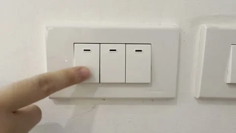 Hand Finger Pressing Light Switch On Off Wall  Close Up 4K HDR Editorial Stock Footage 335698133