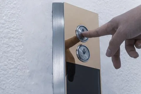 Hand finger push the elevator button up or lift Foto stock