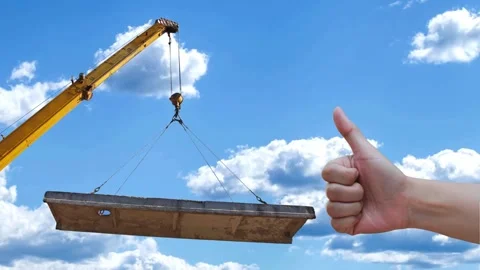 A hand fist shows thumbs up for command the crane is lifting the workpiece up Stock Footage 313091771
