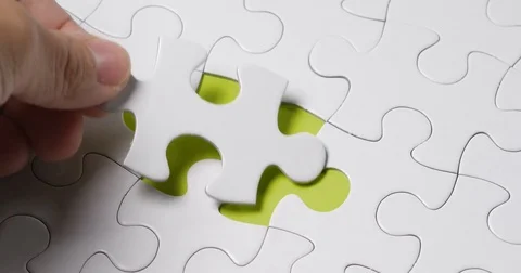 Hand fitting the last puzzle piece Stock-Footage 84832017