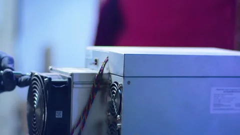 Hand Fixing Cooling System on High-Power ASIC Bitcoin Miner. Stock Footage 321211339
