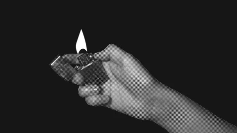 Hand flicking a lighter to ignite a flame with flying sparks. Stock Footage 342754374