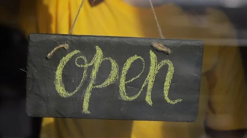 Hand flip nameplate saying close on cafe Stock Footage 129341889