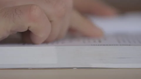Hand Flipping Book Pages During Reading. Close-Up shot. Guy Reading Book Stock Footage 148557084