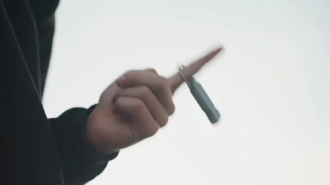 Hand flipping key. Detailed shot of hand controlling key fob against sky Stock Footage 338004584