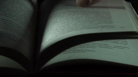 The hand is flipping the page of the book Stock Footage 55369621