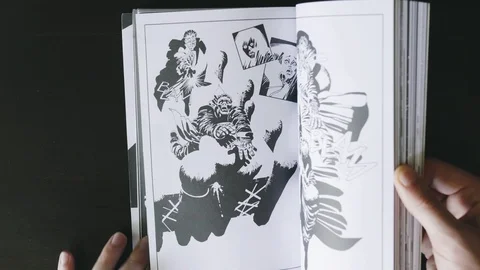Hand flipping pages of comic book top view Stock Footage 92525951