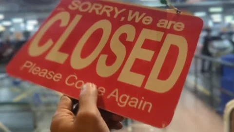 Hand Flipping Reversible Open and Closed Signboard on Glass Door Stock Footage 328973094