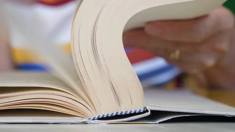 Hand Flipping Through Pages of a Book Stock Footage 284343994