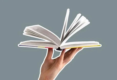 Hand flipping through the pages of an open book, symbolizing education and Stock Photos