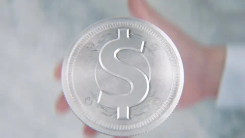 A hand flips a coin marked Dollar Symbol and Euro Symbol, spinning toward t.. Stock Footage 296366846