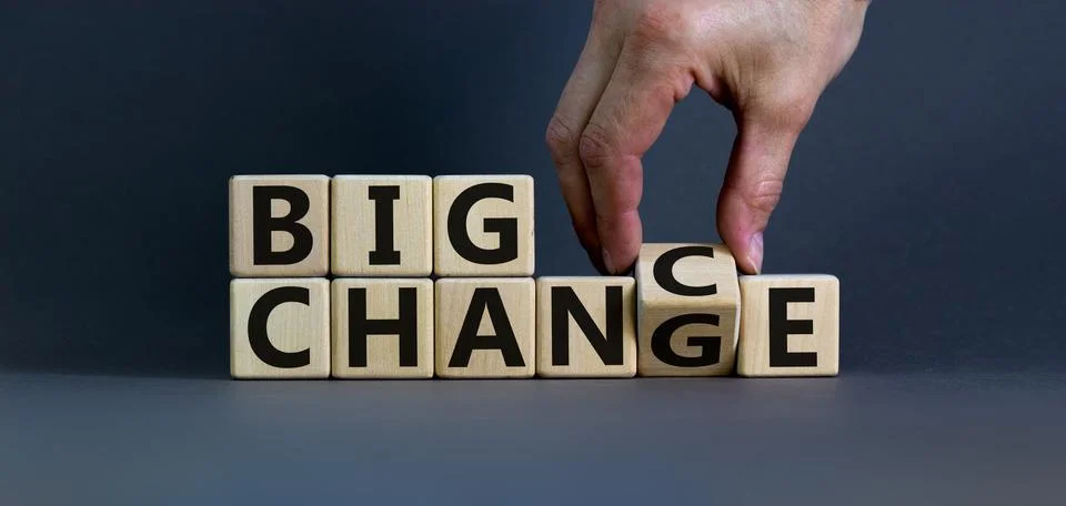 Hand flips a cube and changes the words 'big change' to 'big chance'. Beautif Stock Photos