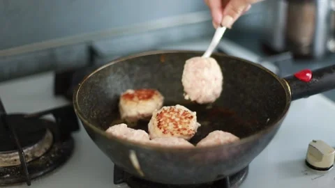 Hand flips cutlets Stock Footage 204014914