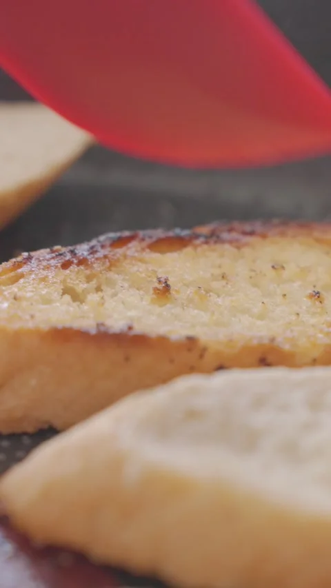 Hand flips slice of bread in frying pan with a spatula in closeup Stock Footage 337323972