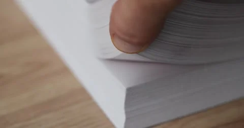 Hand flips through stack of white blank sheets of paper Stock Footage 245616408
