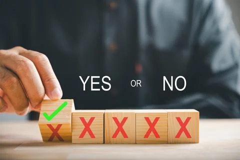 Hand flips wooden cube changing red cross to correct tick icon for project Stock Photos