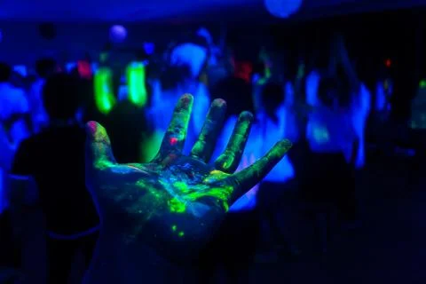 Hand with a fluorescent paint Stock Photos