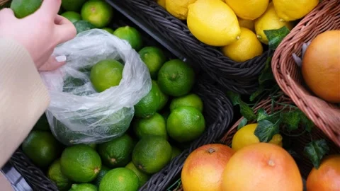 Hand folds a lime in a plastic bag close-up, concept of shopping in vegetable Stock Footage 172844713