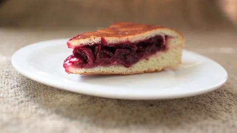 Hand with a fork breaking an appetizing fresh cherry homemade pie. Stock-Footage 90495791
