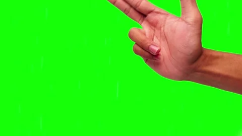 Hand forms a gesture against green screen backdrop Stock Footage 295537929