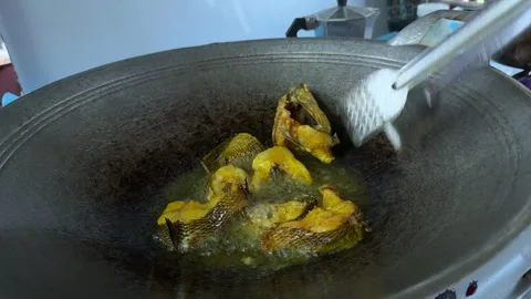 Hand Frying Fish Using Tongs In Hot Oil Stock Footage 328487086